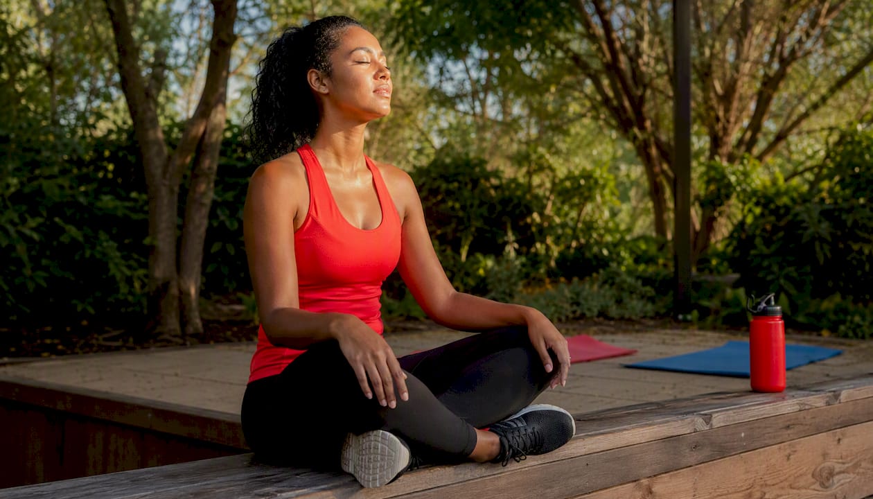 Female athlete stretching post workout indoors