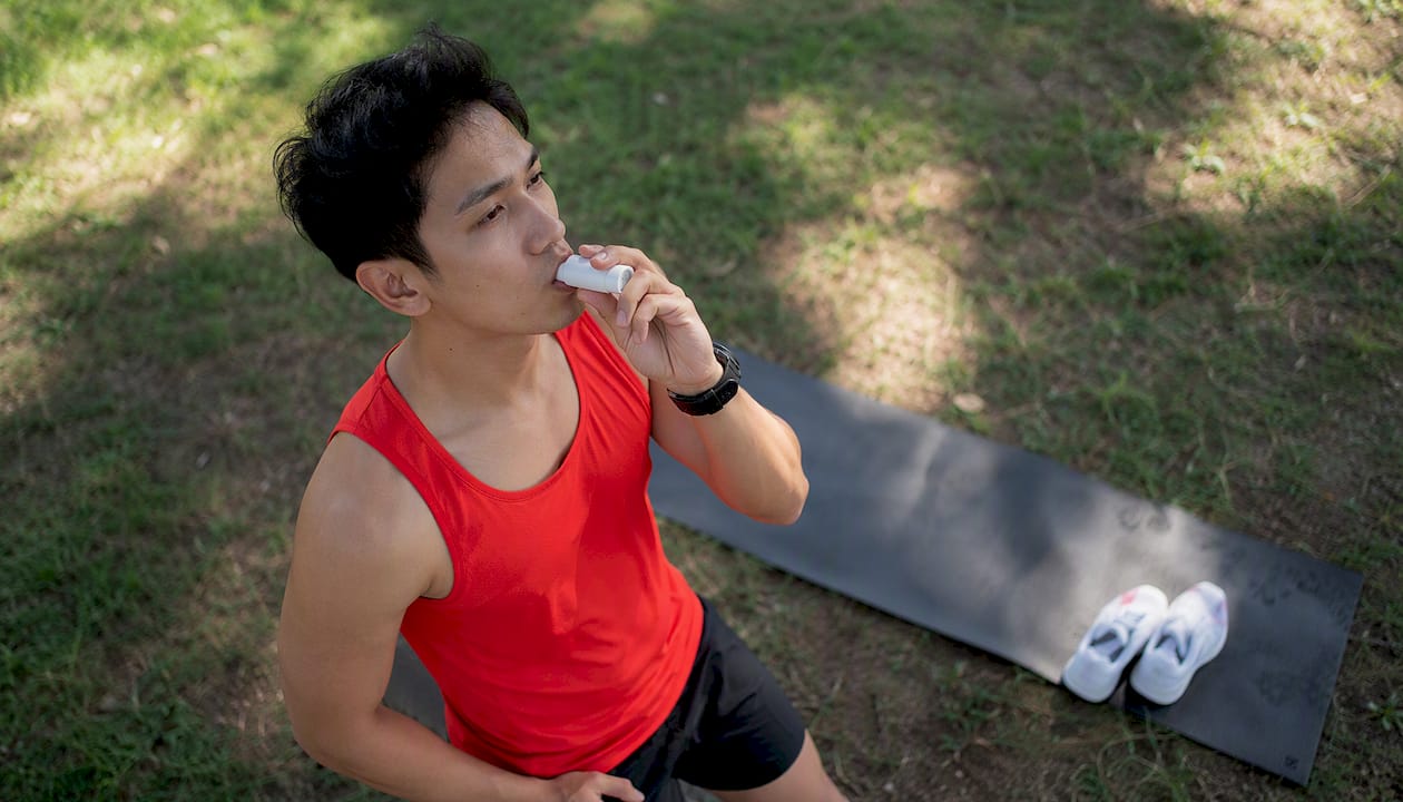 Athlete inhaling supplemental oxygen outdoors