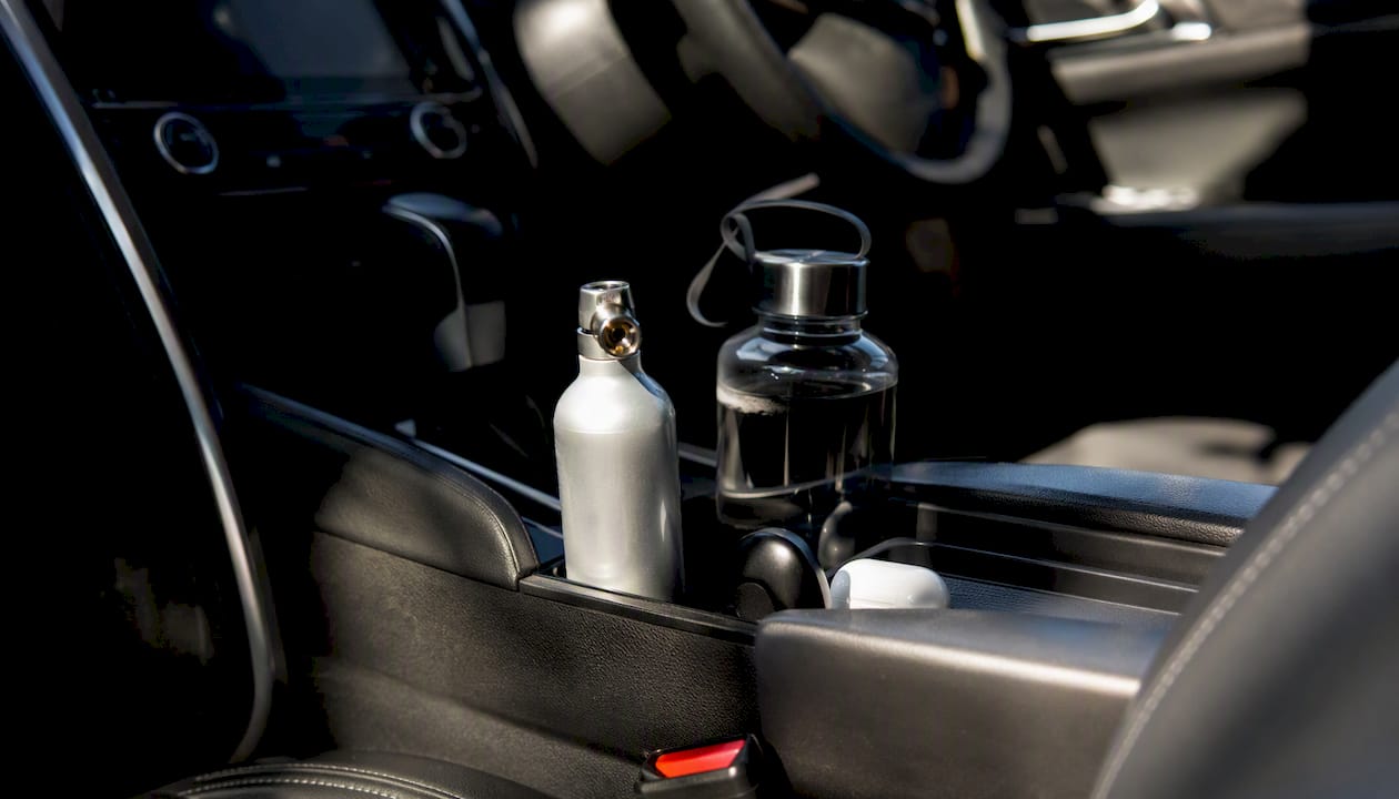 Oxygen canister stored upright in car compartment