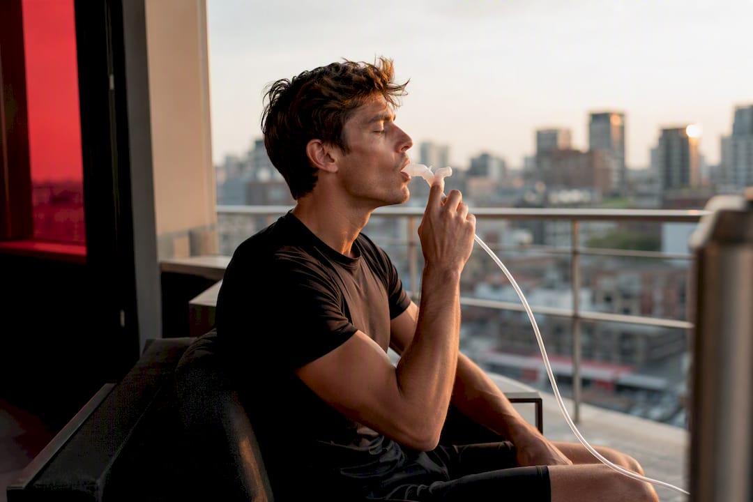 Athlete inhaling oxygen through mouthpiece