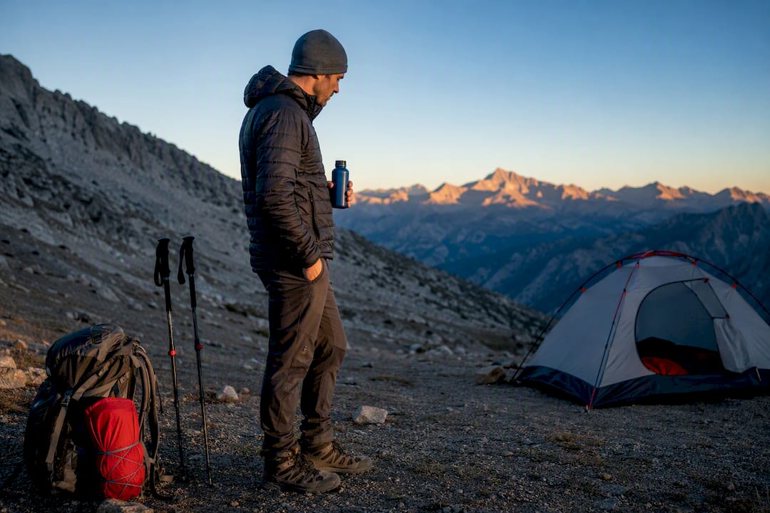 Hiker assessing recovery at mountain campsite